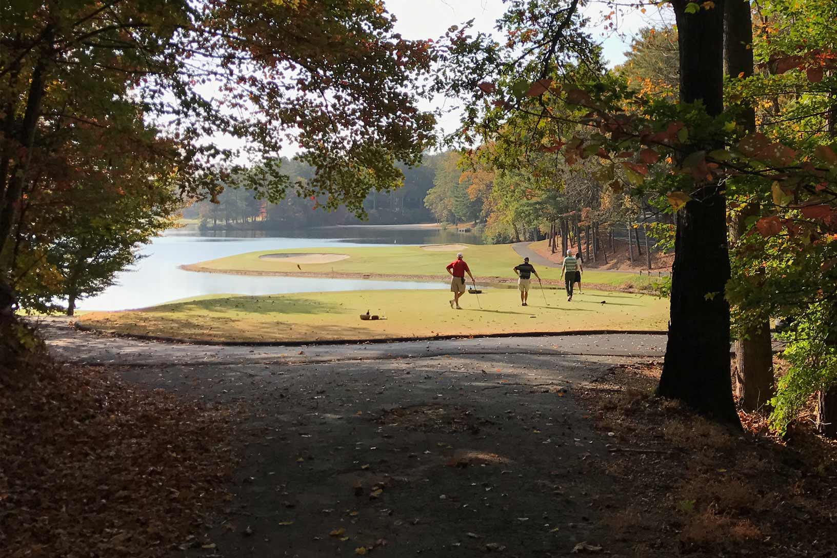 A group of golfers teeing off at Big Canoe