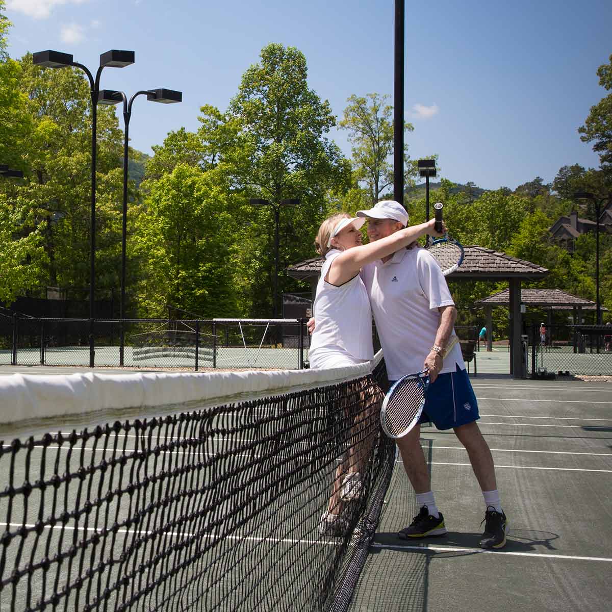 Couple playing tennis at Big Canoe